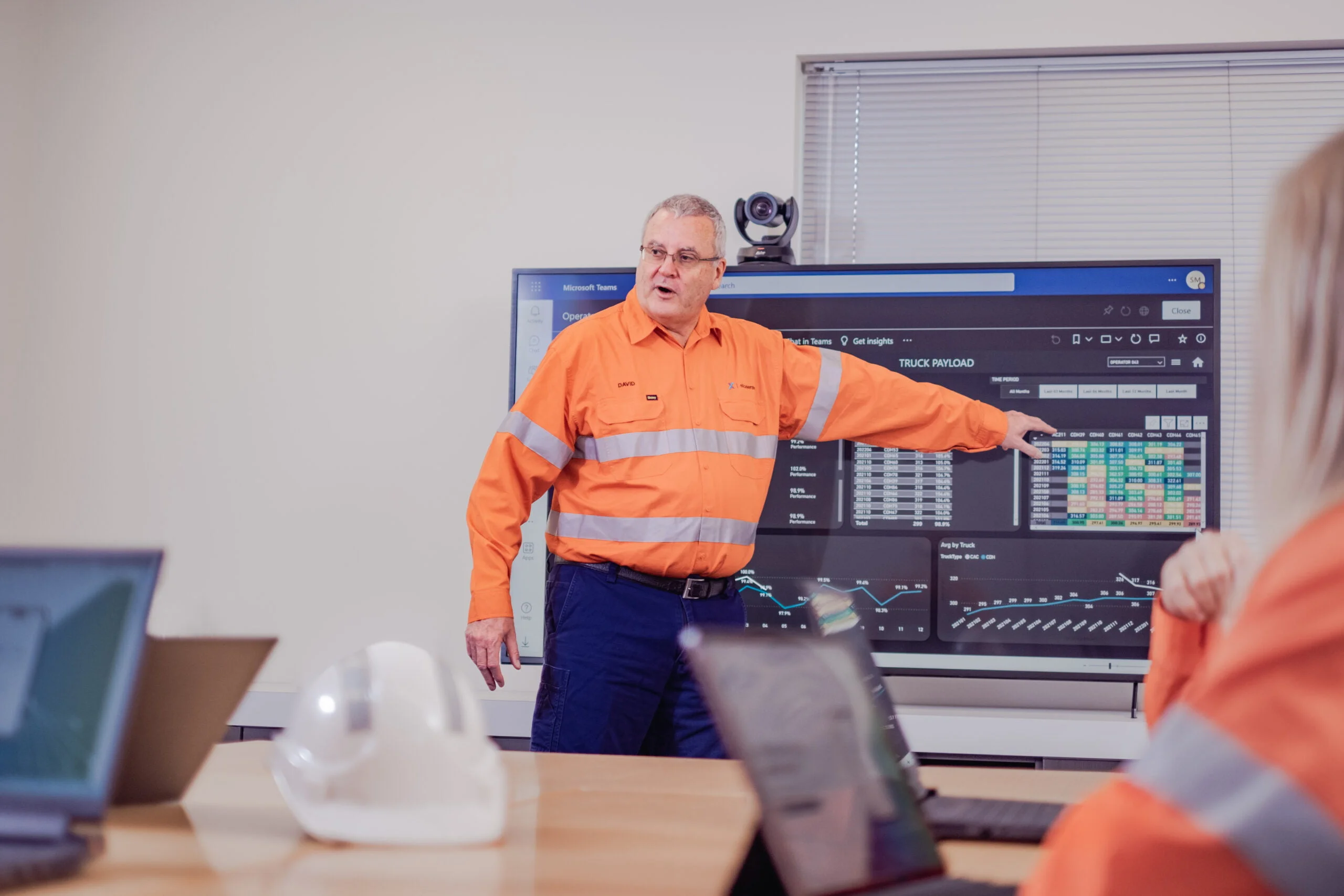 Man pointing at presentation screen.